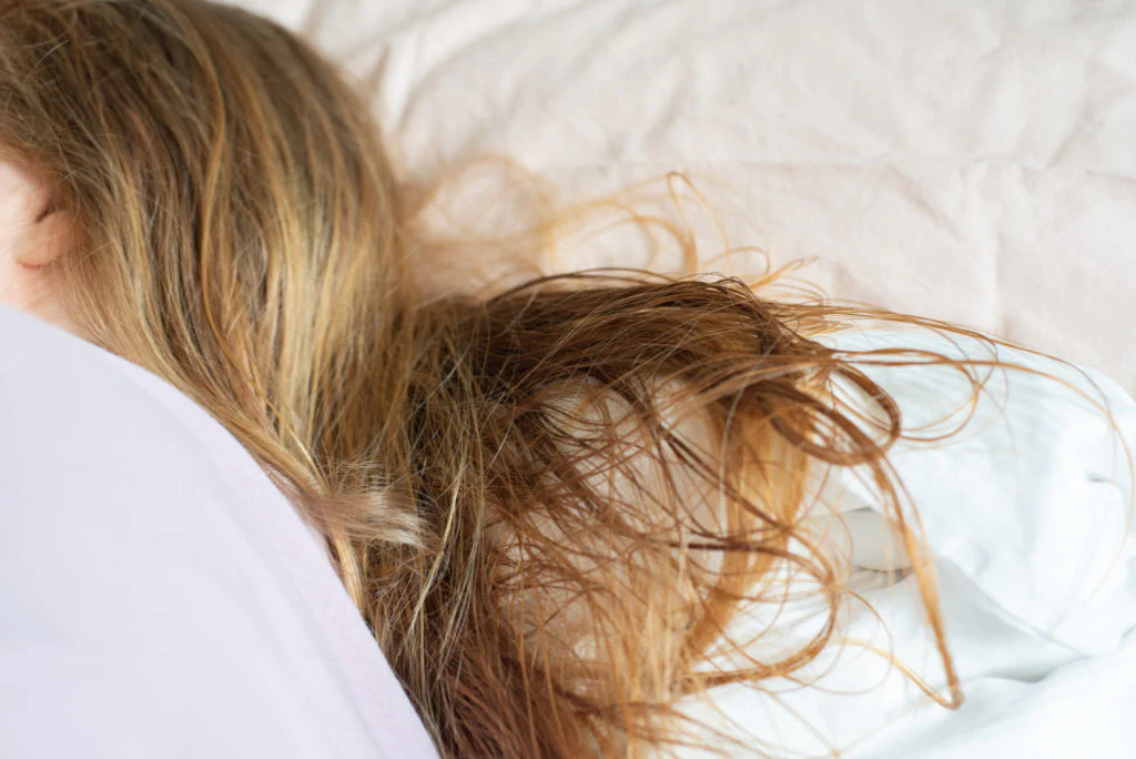 Going to bed with unprotected hair extensions.